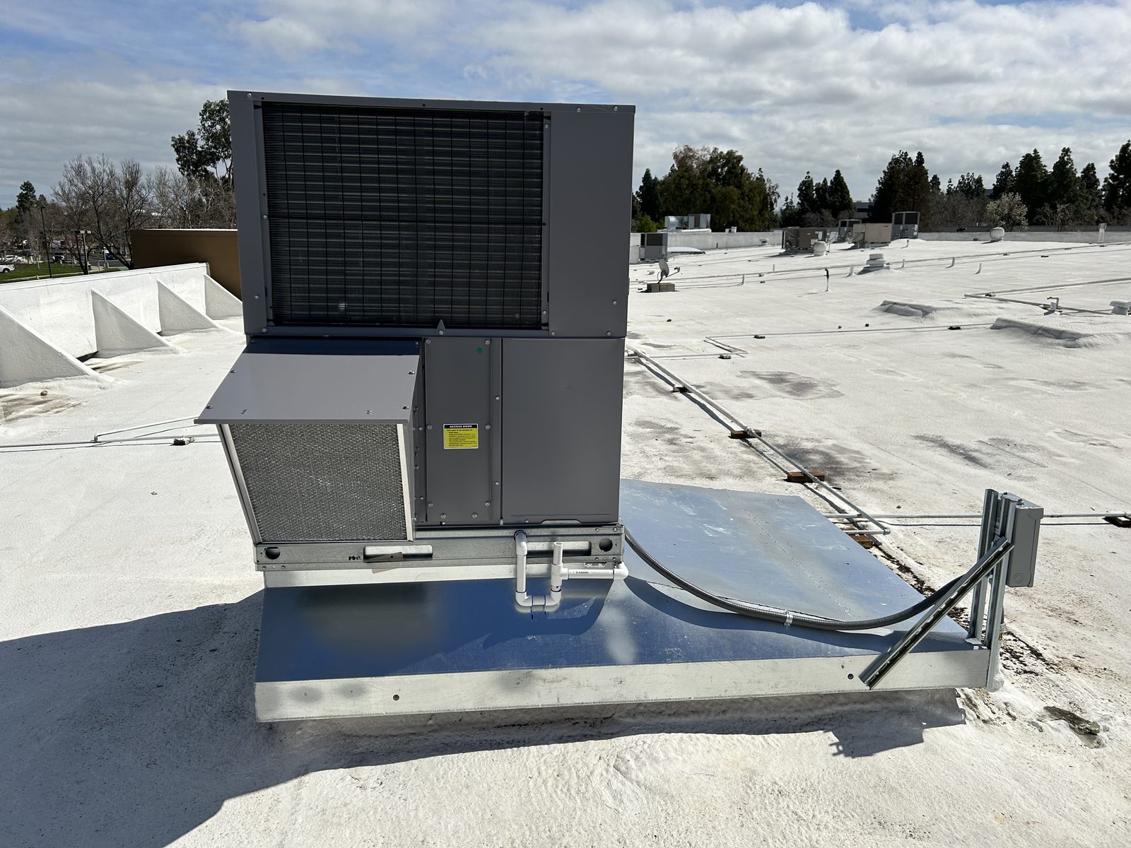 Replacement rooftop unit installed on a custom made curb adapter